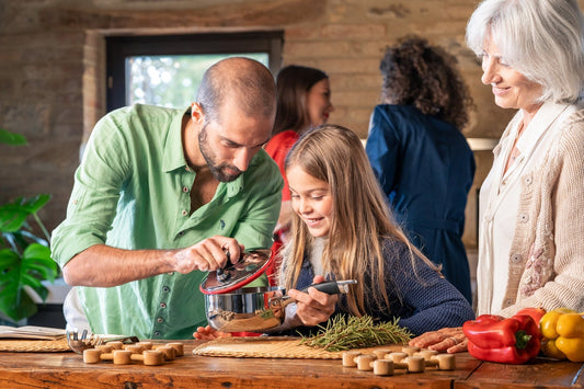 Adult and child cooking together in a warm kitchen, showing how shared activities support family connection and learning