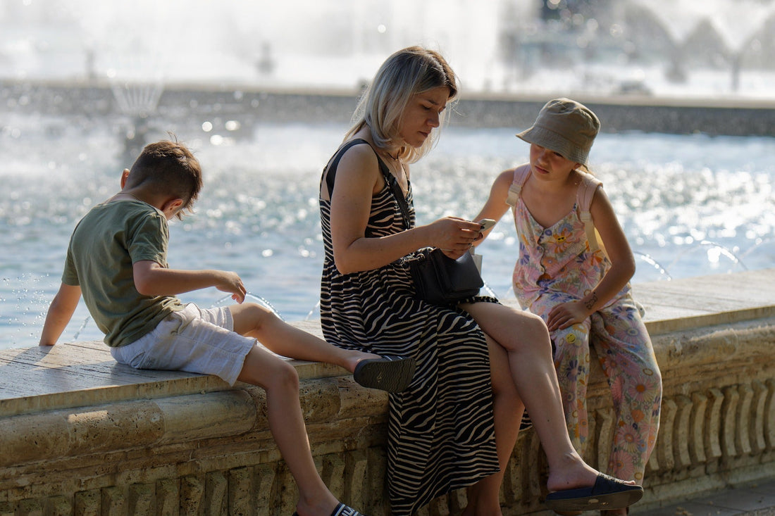 Parent sitting with children during a quiet moment, showing how busy routines and divided attention can affect family connection